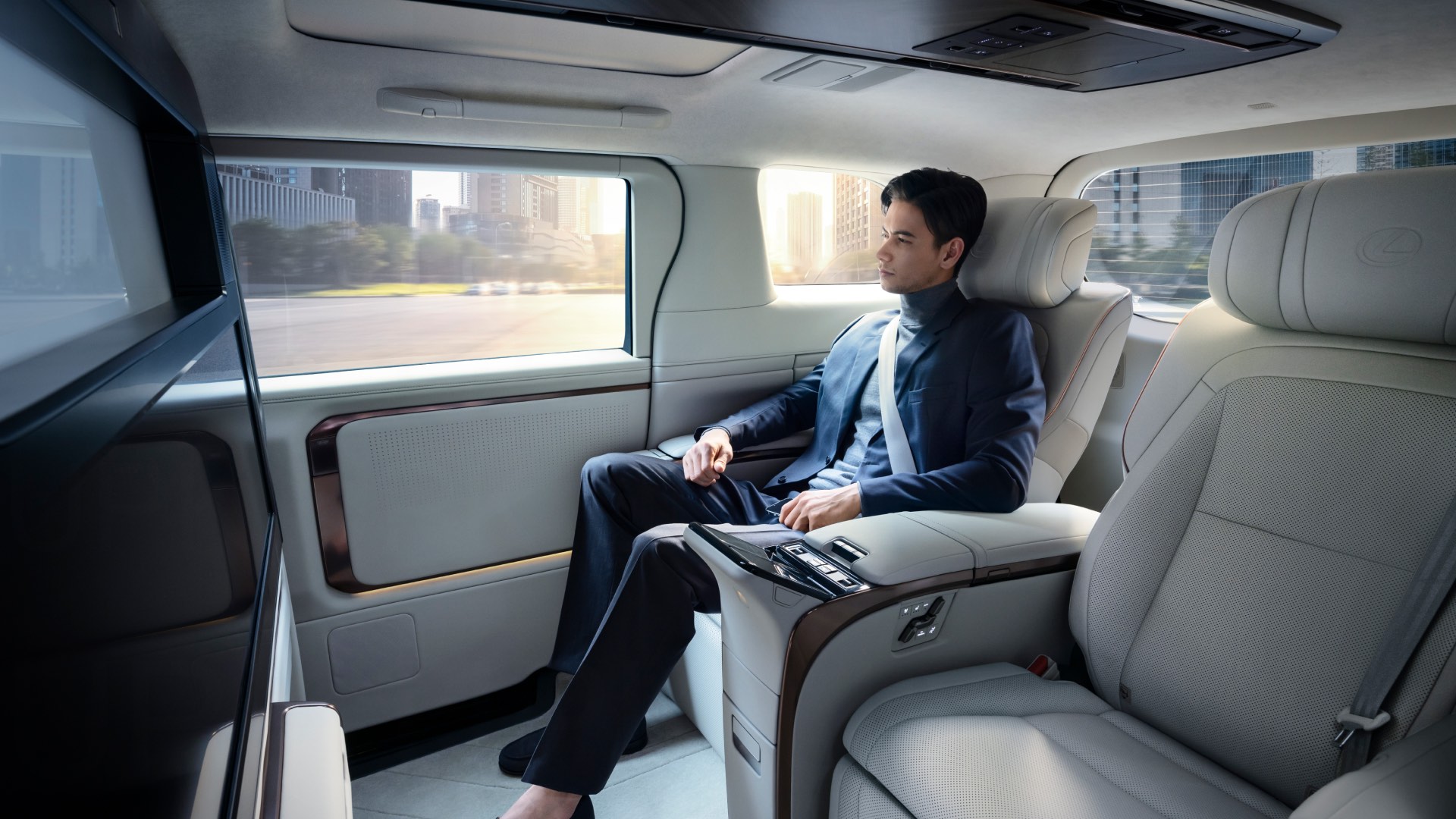 Man sits and enjoys the opulent interior of the Lexus LM. His legs are stretched out.