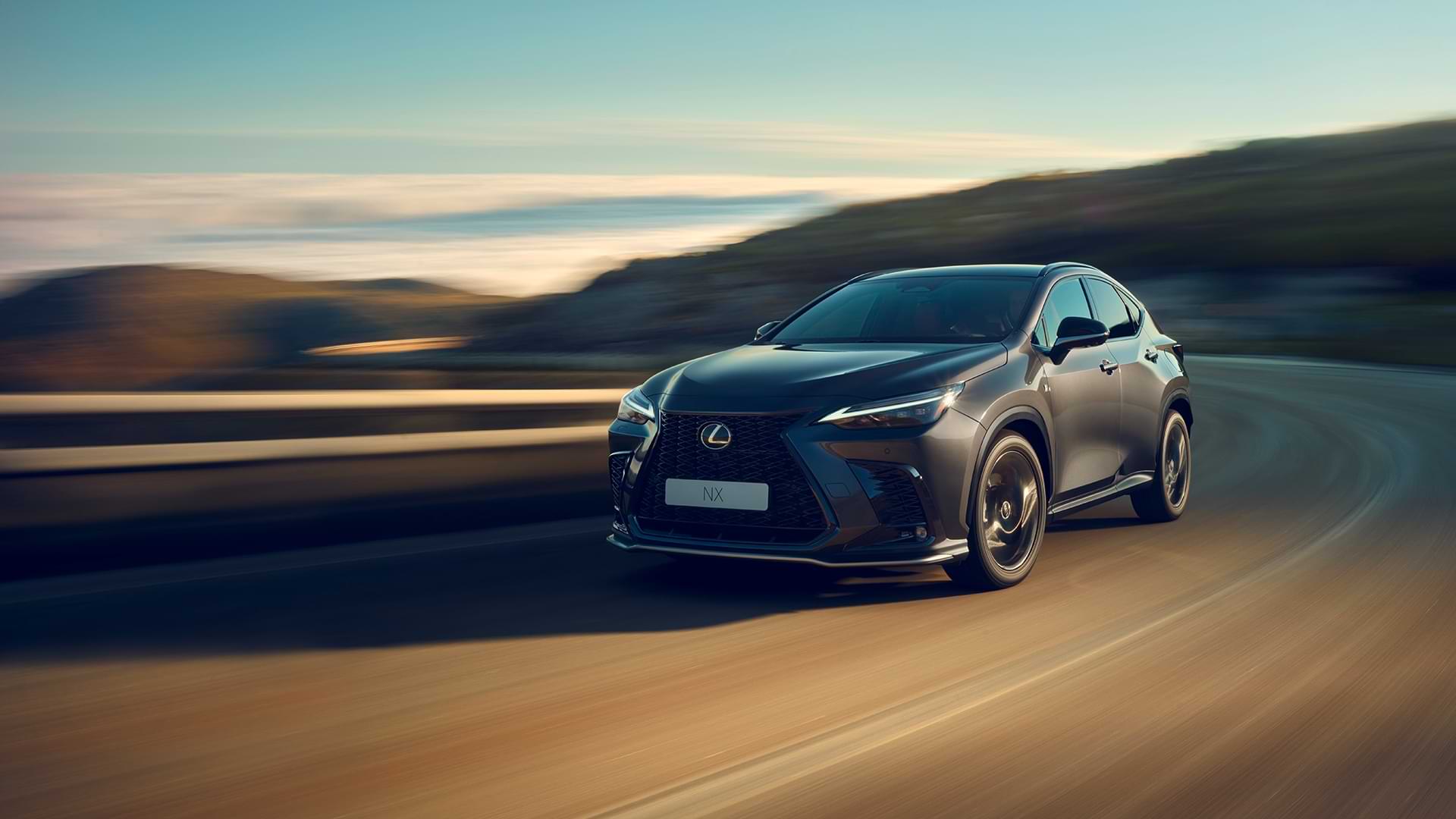 NX speeding along a crimson stretch of road, which is blurred.