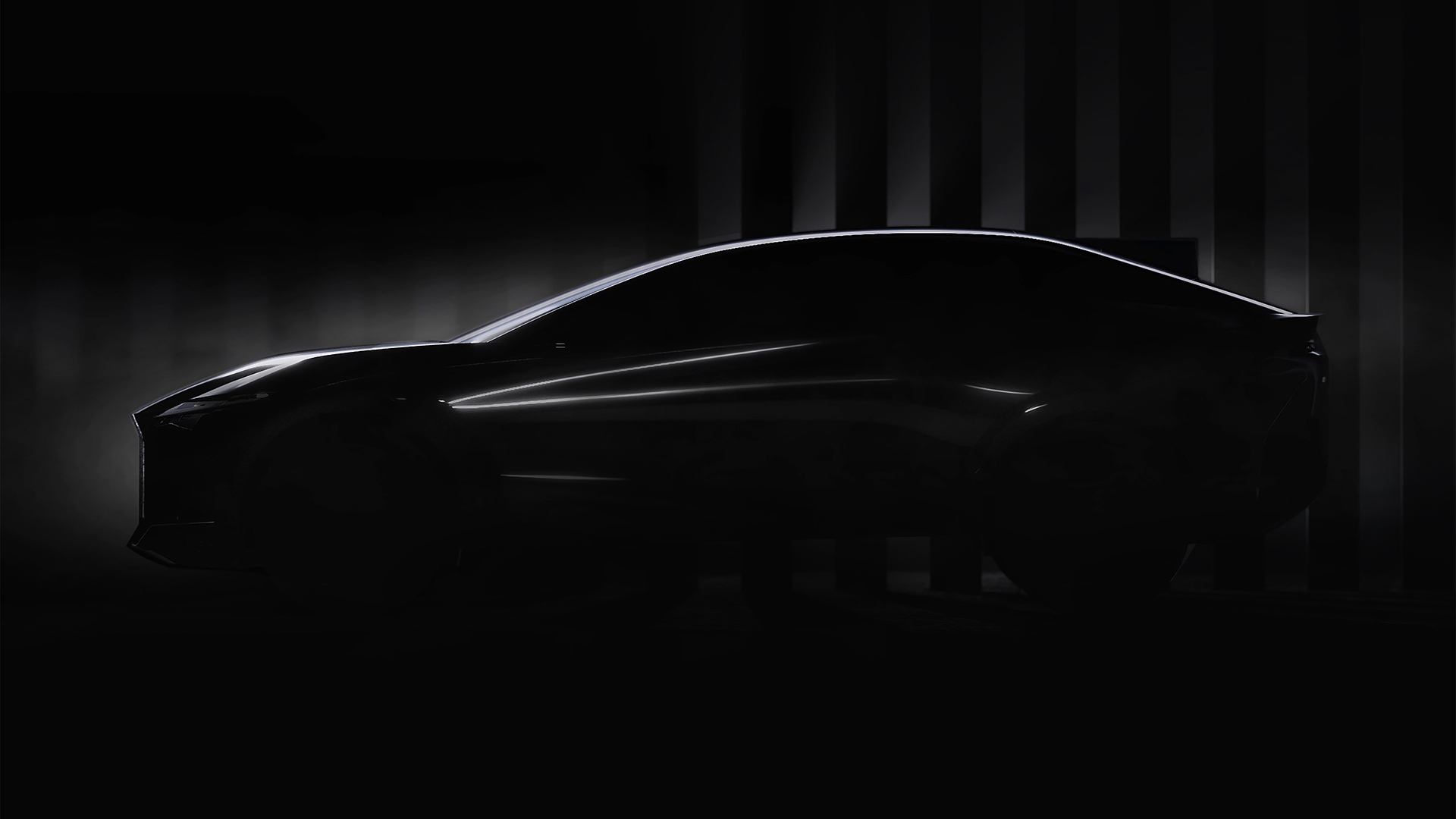 Lexus LF-Z concept vehicle appears all in black, shadows eliciting the shape of the sedan shaped body.